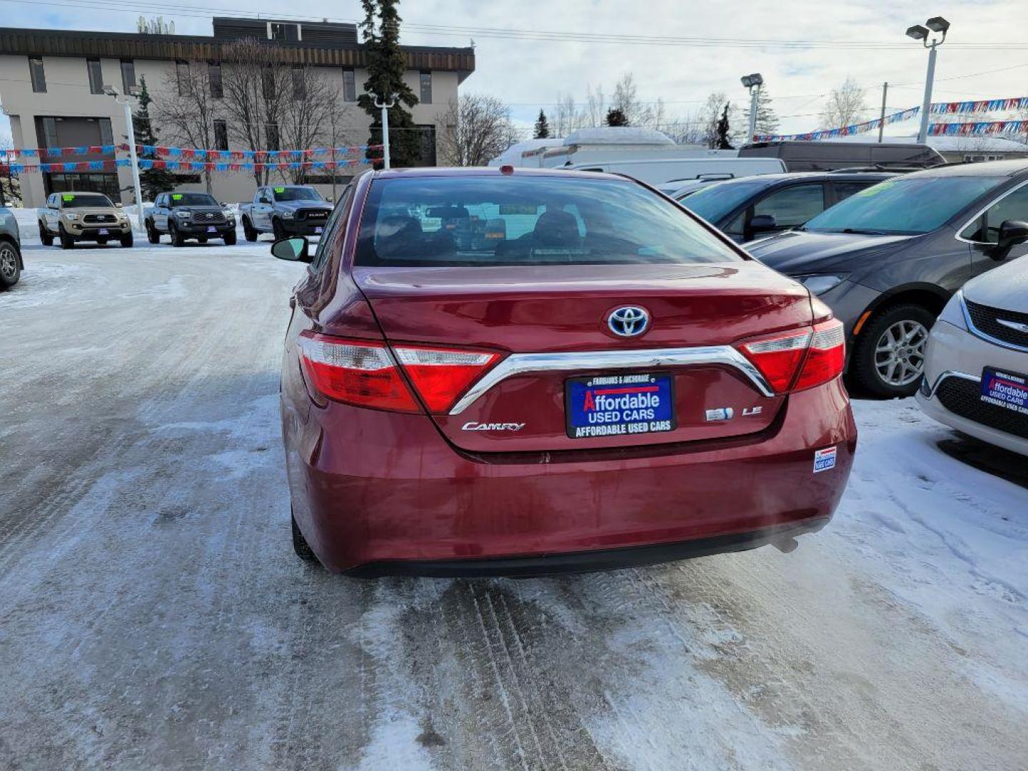 2016 RED TOYOTA CAMRY HYBRID (4T1BD1FK0GU) with an 2.5L engine, Continuously Variable transmission, located at 929 East 8th Ave, Anchorage, AK, 99501, (907) 274-2277, 61.214783, -149.866074 - Photo#2