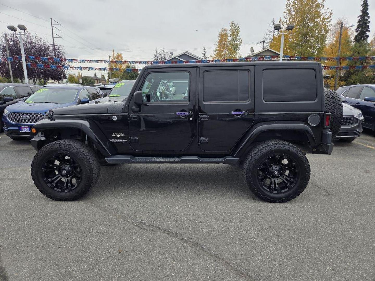 2017 BLACK JEEP WRANGLER UNLIMI SAHARA (1C4HJWEG4HL) with an 3.6L engine, Automatic transmission, located at 929 East 8th Ave, Anchorage, AK, 99501, (907) 274-2277, 61.214783, -149.866074 - Photo#1